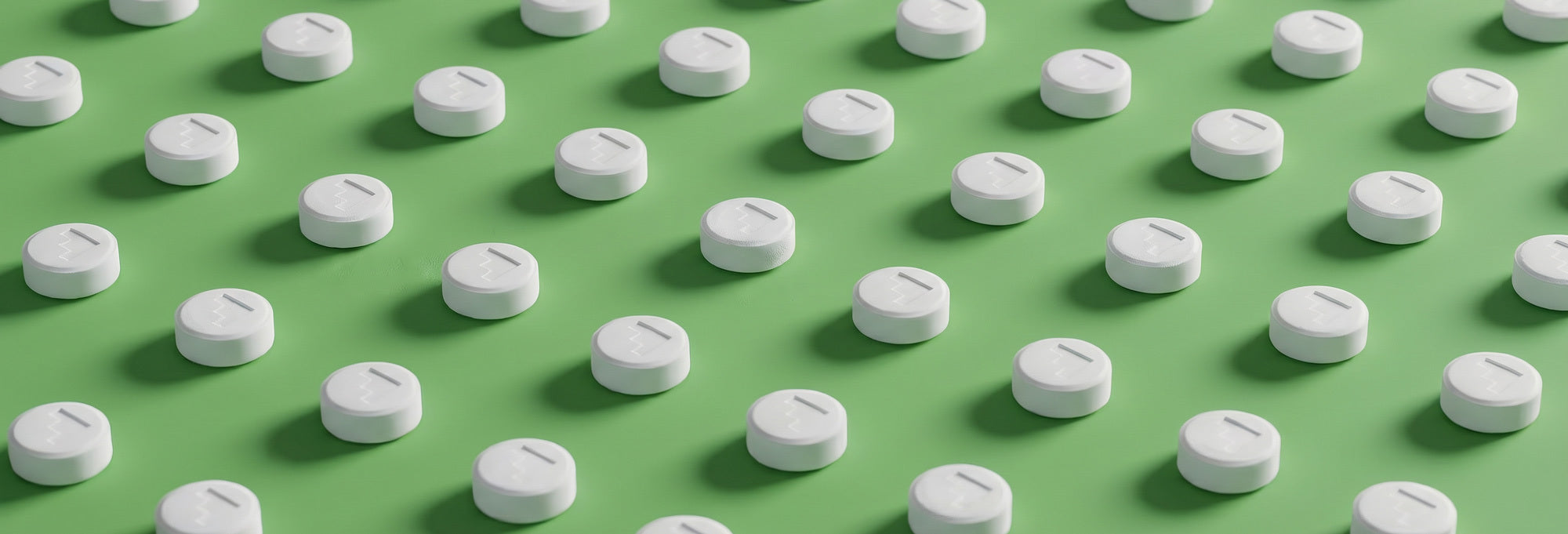CBD Tablets on Green Background
