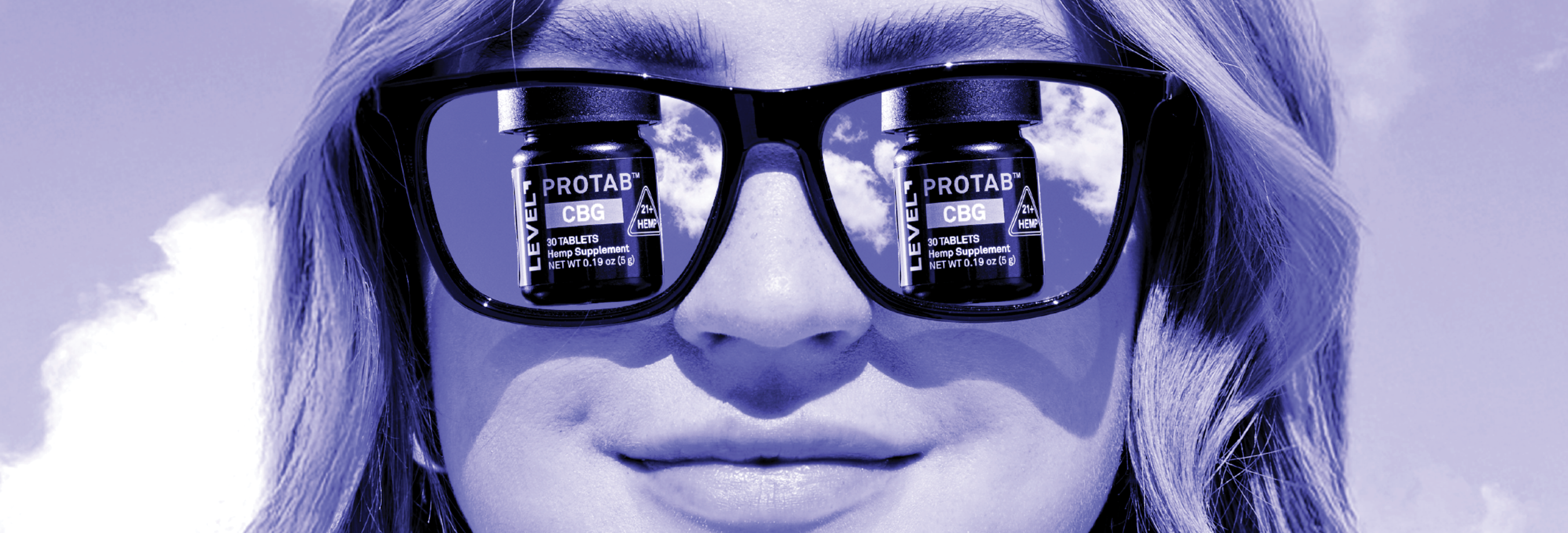 Woman with Glasses viewing CBG Pill Containers