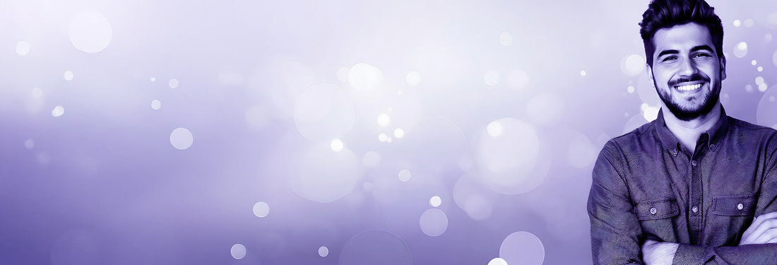 A smiling man in a purple color wash, representing the focus and clarity associated with CBG.