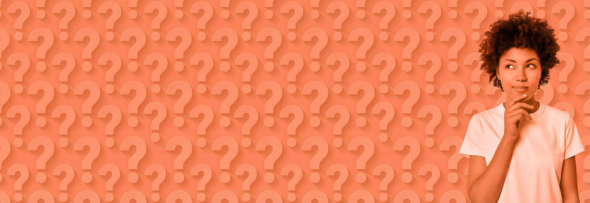 Person holding a snack in front of a pink background with question marks